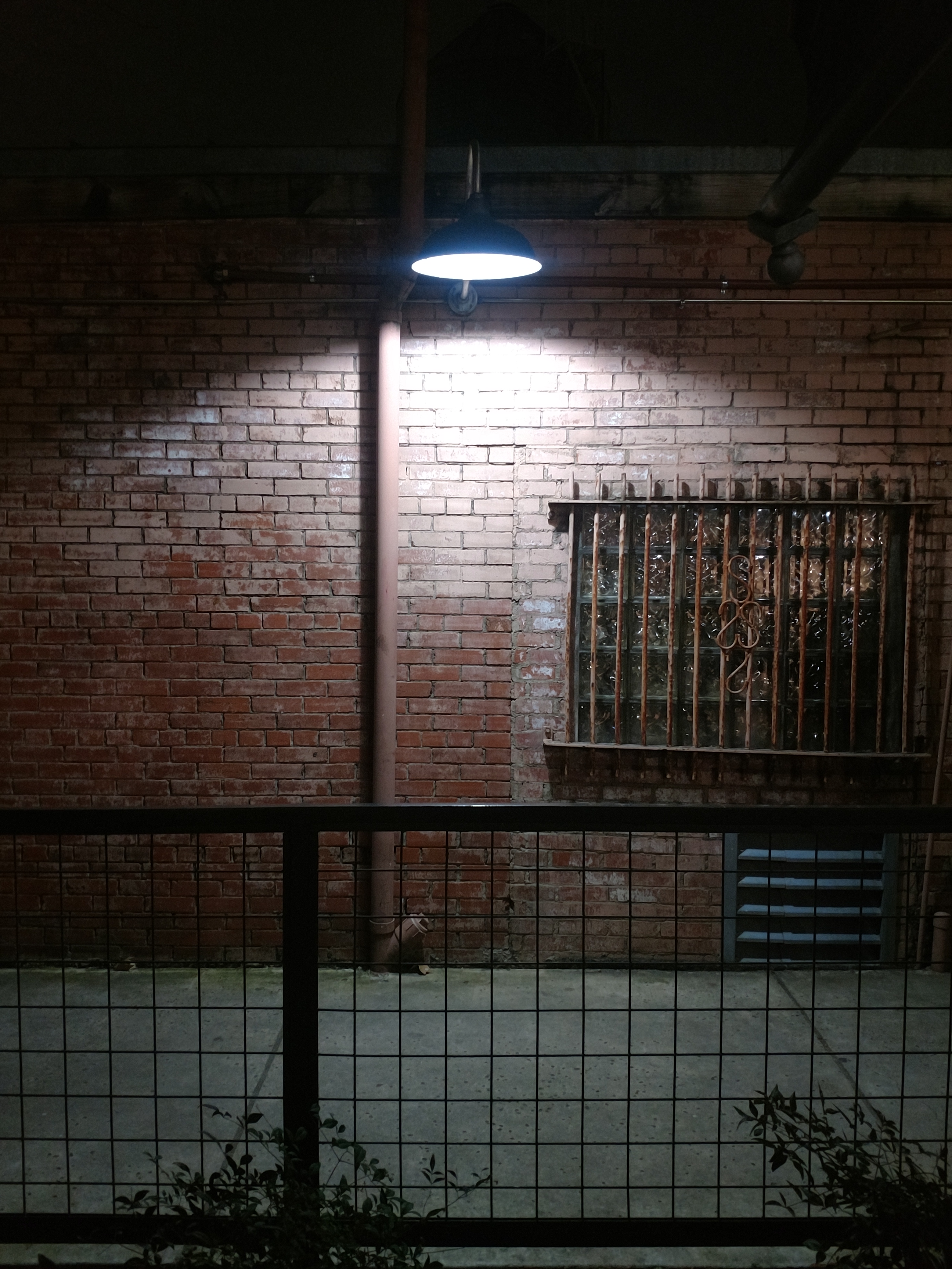 Brick wall in corridor at night