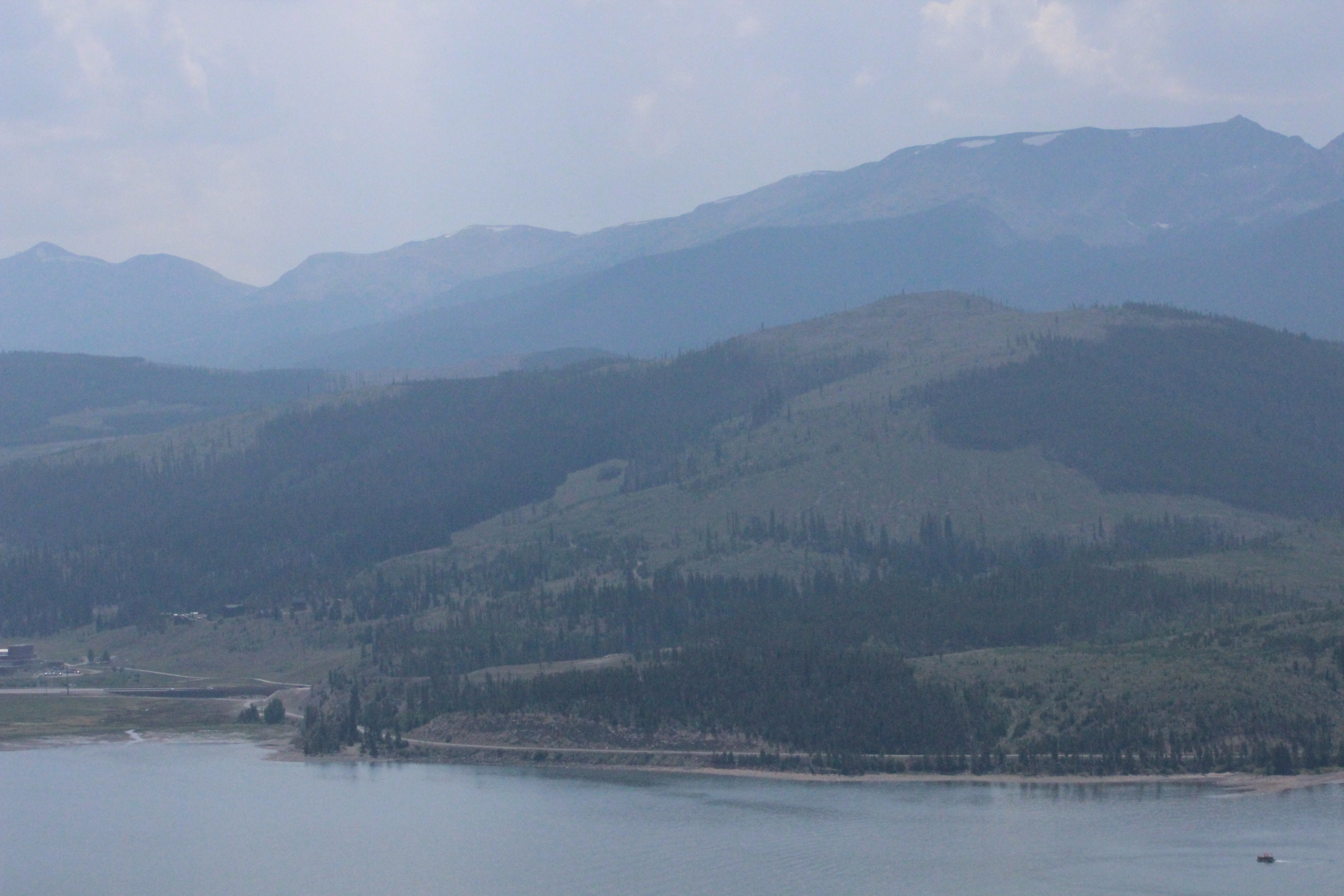 Mountains, trees and water under clear sky